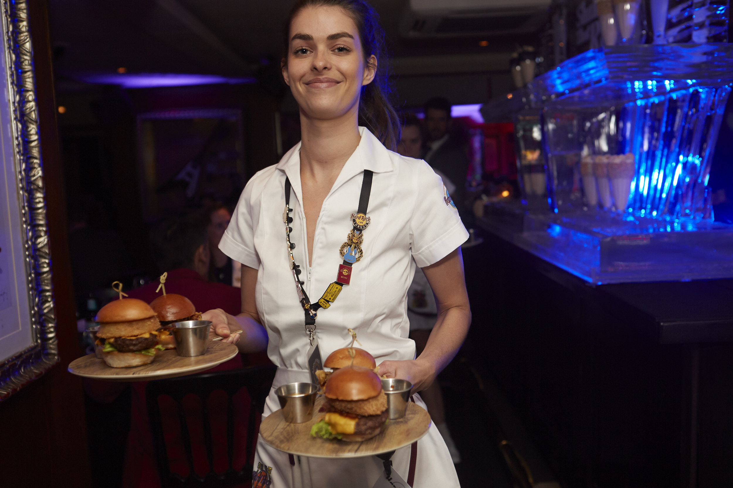 A Hard Rock Cafe waitress serves up the award-winning new steak burgers.
